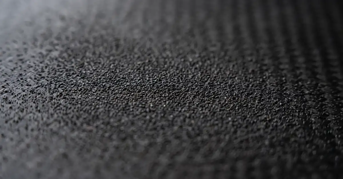 Close-up abstract macro photograph of a pickleball paddle face texture