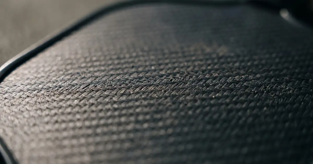 Abstract close-up of a textured paddle face catching soft light, no brand marks visible